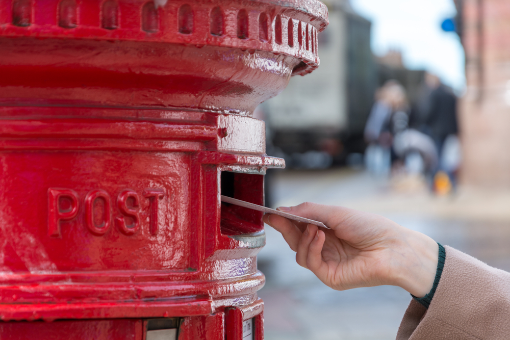 Posting A Letter Through A Post Box